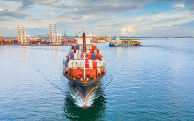 Cargo ship loaded with containers sailing across the sea for global air cargo logistics management services