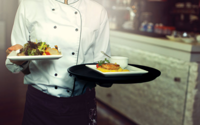 Waiter serving food to guests in a hospitality setting for Online Diploma in Food & Beverage Service courses