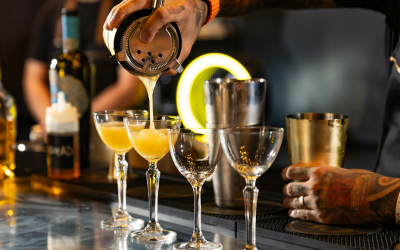 Bartender pouring wine into glasses during service training for Online Bartending Course For Beginners