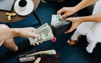 Traveler exchanging foreign currency at airport counter for international travel and tourism services